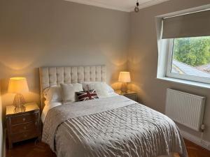 a bedroom with a bed with two lamps and a window at Richmond-On-Thames, London, Luxery Apparment With Balcony in Richmond