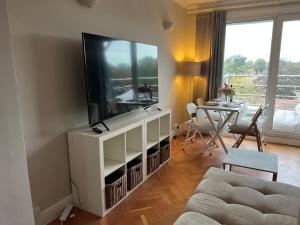 a living room with a large flat screen tv at Richmond-On-Thames, London, Luxery Apparment With Balcony in Richmond