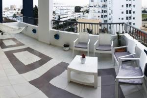 a balcony with chairs and a table on a building at The jewel of the coast in Sousse