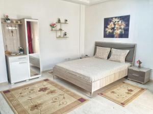 a bedroom with a bed and a mirror at The jewel of the coast in Sousse