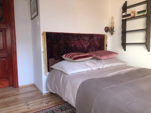 a bedroom with a bed with two pillows on it at Stara Kamienica in Szczytno