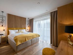 Un pat sau paturi într-o cameră la Appartements ALMA