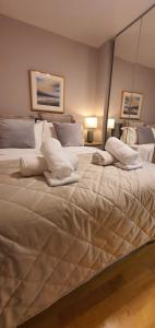 a large bed in a bedroom with two pillows at The Beautiful Bankmore Penthouse in Belfast