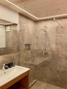 a bathroom with a shower and a sink at Haus Glasella in Schruns-Tschagguns