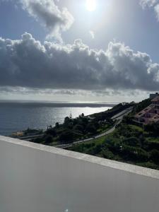 a view of the ocean from a balcony at Penthouse Palmeira in Gaula