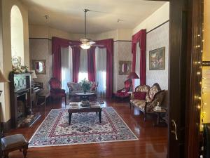 a living room with a couch and a table at Grand Gables Inn in Palatka