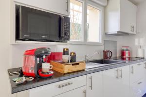 a kitchen with a red appliance on a counter at Silver&Gold House Pro & Family in Ivry-sur-Seine +8 photos