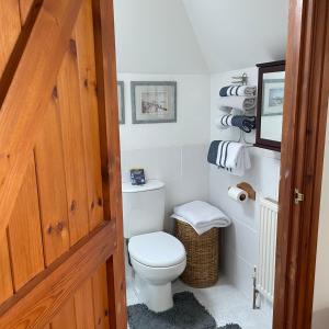 a bathroom with a white toilet and towels at Carraholly in Liskeard