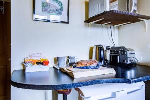 a black counter top with a coffee maker on it at Entire Studio with Ensuite balcony and parking in Westcliff On Sea