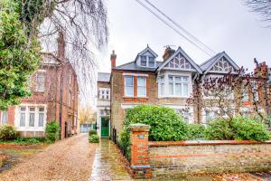 a brick house on a cobblestone street at Entire Studio with Ensuite balcony and parking in Westcliff On Sea