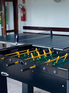 a ping pong table with a ping pong ball on it at Apartamento Pé na Areia in Caraguatatuba