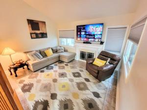 a living room with a couch and a tv at Nice 2BDR near Airport with fast WiFi / Metro / Parking in Herndon