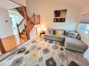 a living room with a couch and a table at Nice 2BDR near Airport with fast WiFi / Metro / Parking in Herndon