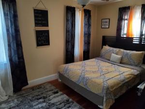 a bedroom with a bed with curtains and a rug at Weyanoke in Petersburg