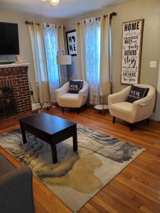 a living room with two chairs and a coffee table at Weyanoke in Petersburg