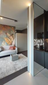 a living room with a bed and a kitchen at Hanza Tower Studio in Szczecin +21 photos