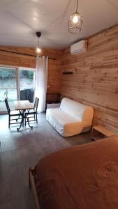 a bedroom with a bed and a desk and a table at Le chalet de La Treille in Marseille