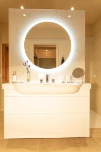 a bathroom with a white sink and a mirror at Premium Eco Chalet 1888 in Bad Sankt Leonhard im Lavanttal +80 photos