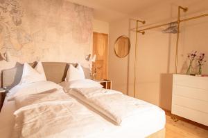a bedroom with two beds with white sheets at Premium Eco Chalet 1888 in Bad Sankt Leonhard im Lavanttal