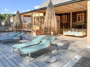 a patio with two lounge chairs and a house at Premium Eco Chalet 1888 in Bad Sankt Leonhard im Lavanttal