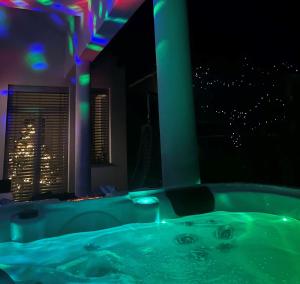 a jacuzzi tub in a room at night at Casa M in Lopatinec