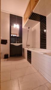 a large bathroom with a sink and a shower at Ola Blanca Sidi rahal Apparthotel in Sidi Rahal
