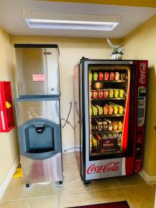 a coca cola refrigerator next to a soda machine at Mountain inn & suites - Dunlap TN in Dunlap