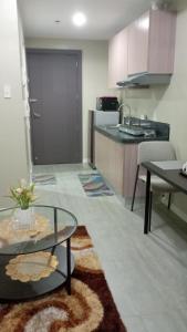 a living room with a kitchen and a table at Nahas Condo Hotel in Manila