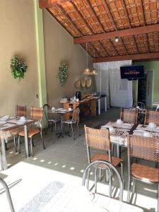 un comedor con mesas y sillas en un restaurante en Pousada Brisa do Sul, en Santa Cruz Cabrália