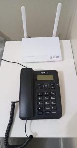 a phone sitting on top of a white desk at Nahas Condo Hotel in Manila