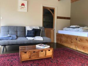 a living room with a couch and a coffee table at The Stone Cottage - Bruny Island in Simpsons Bay