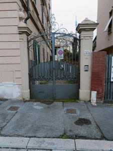 a gate to a building with a no parking sign on it at Garden House in Florence