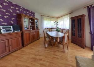 a kitchen with a table and chairs in a room at Clara Valis - Village House in Doľany