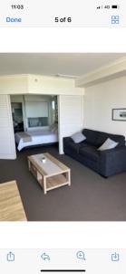 a living room with a couch and a coffee table at Resort One Bedroom Apartment in Pelican Waters