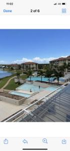 a screenshot of a picture of a building with two pools at Resort One Bedroom Apartment in Pelican Waters