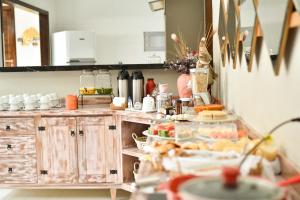 a kitchen with a counter with food on it at Lukinhas Pousada in Estivado
