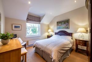 a bedroom with a large bed and a desk at Kenmare Townhouse in Kenmare
