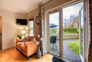 a living room with a couch and a sliding glass door at Kenmare Townhouse in Kenmare