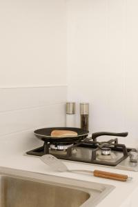 a stove top with a pan on top of it at Tatapouri Bay in Gisborne