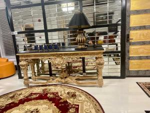 a gold table with a lamp on top of it at Prestige Collection, Hotel Boutique in St Petersburg