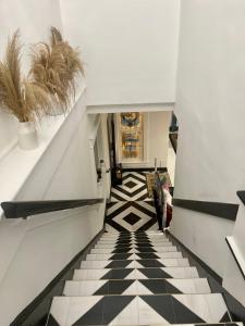 a hallway with a black and white tiled floor at Prestige Collection, Hotel Boutique in St Petersburg