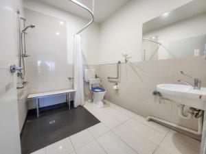 a bathroom with a sink and a toilet and a shower at Exodus Dandenong Apartment Hotel in Dandenong