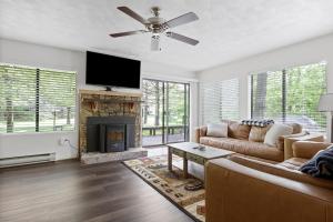 a living room with a couch and a fireplace at Charming Getaway l recently renovated l Hidden Valley l 4BR+3Bath l Hot Tub in Somerset