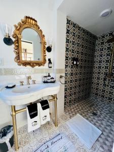 a bathroom with a sink and a mirror at Prestige Collection, Hotel Boutique in St Petersburg