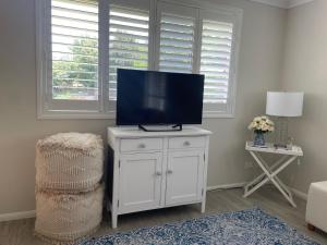 a living room with a television on a white cabinet at Khaman in Preston