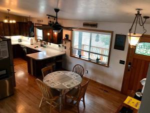 a kitchen with a table and some chairs and a table and a kitchen at Beautiful hideaway at the end of a cul-de-sac in Missoula in Missoula