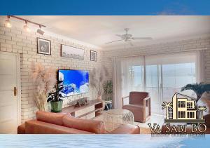 a living room with a couch and a chair at Va sabi bo, Best View, Luxury Family Villa in Hartbeespoort Dam in Hartbeespoort