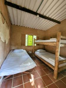 a room with two bunk beds in it at Hostal Dos Quebradas in Santa Marta