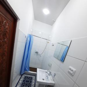 a bathroom with a sink and a shower at Guest House Khiva BOYJON OTA in Khiva