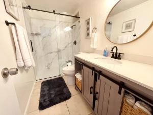 a bathroom with a shower and a sink and a mirror at OCEAN FRONT Beach HOUSE! Private Stairs to SAND! in Laguna Beach